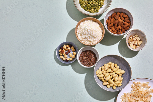 mixed nuts in bowls or mint green background