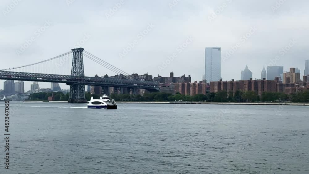 Manhattan New York City East River Ferry approaching to Brooklyn North Williamsburg Terminal underneath Williamsburg Bridge on a hazy day Manhattan New York City East River Ferry approaching to Brooklyn North Williamsburg Terminal underneath Williamsburg Bridge on a hazy day