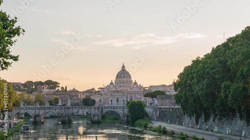 zoom out fast day to night timelapse by the Tibre river with the classic Vatican City view and Sant'Angelo castle. Famous attraction located within Rome, Italy. cityscape Vaticano, Roma, Italia. photo