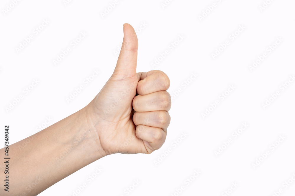 Closeup of female hand showing thumbs up sign against white background. Closeup of female hand showing thumbs up sign against white background.
