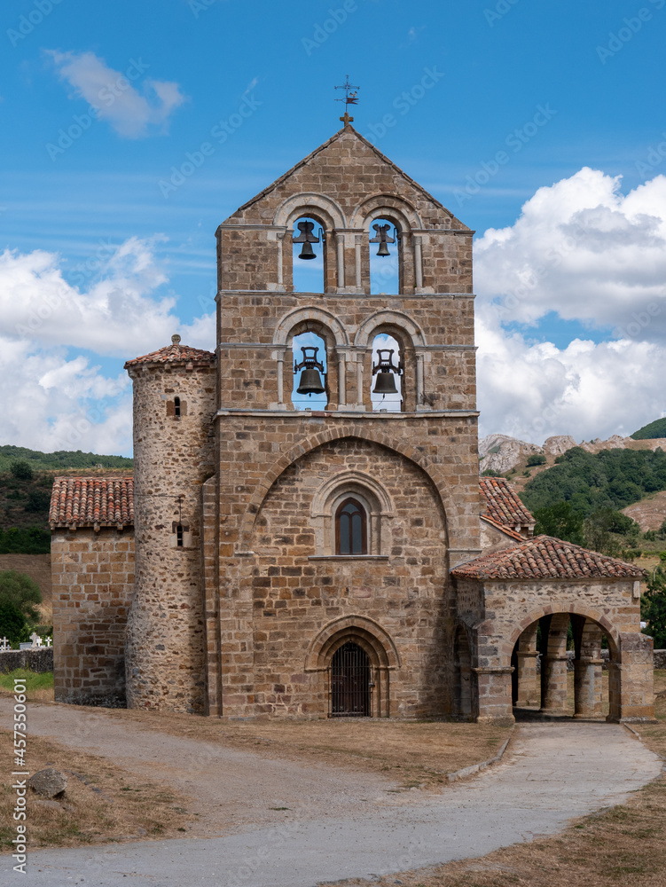 The beautiful facade with bell tower of the stone church of a town in Spain