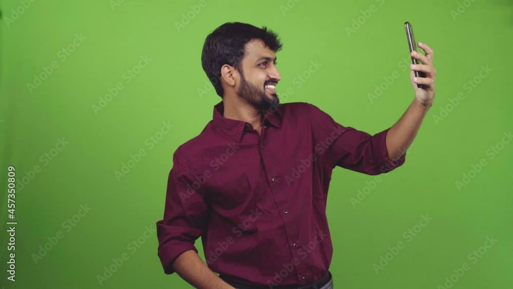 Young handsome man from Asian rejoicing his success in a green screen shoot. Young handsome man from Asian rejoicing his success in a green screen shoot.