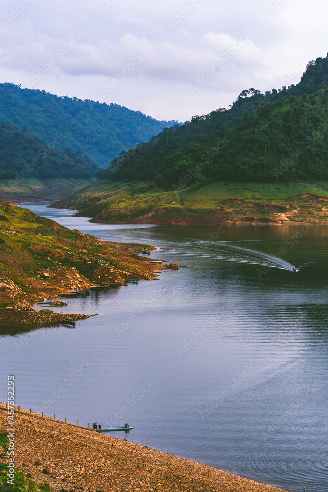 Naklejka premium A resoervoir with the mountain background at Dam Khun Dan Pra Kan Cho, Nakhonnayok, Thailand