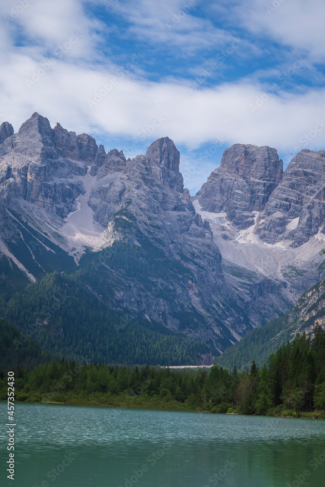 A majestic view of Durrensee lake in Italy surrounded by beautiful forested mountains in the Dolomites at summer