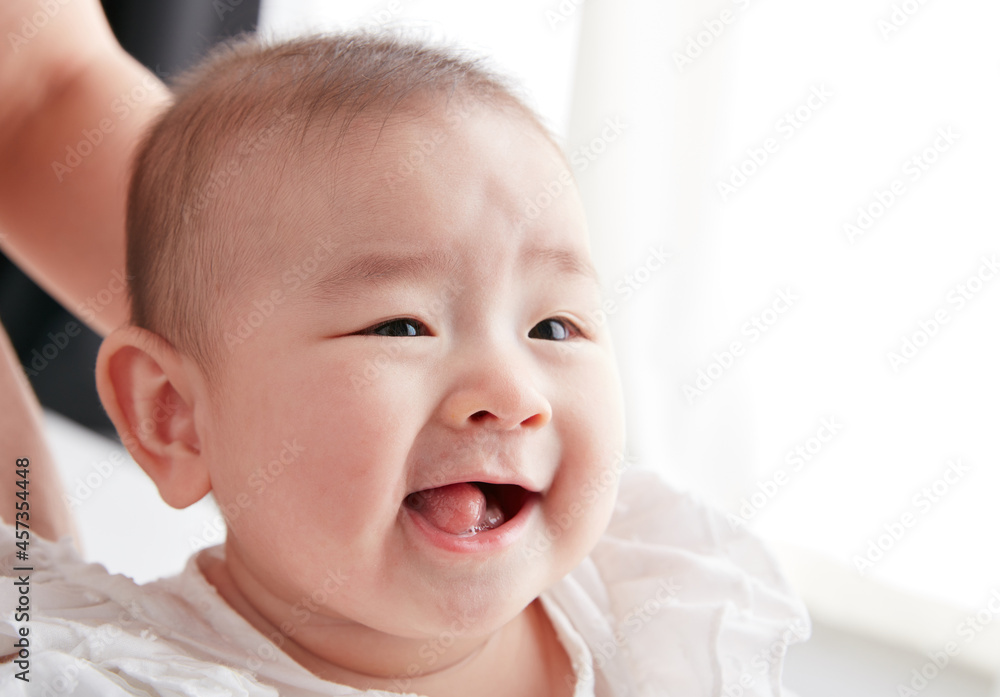 Cute Asian baby lying in mother's arms Cute Asian baby lying in mother's arms