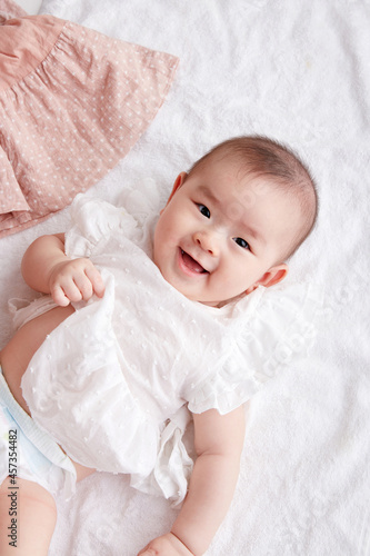 Cute Asian baby lying on the floor and playing