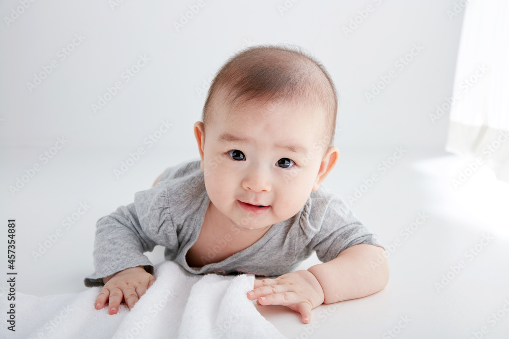 Close-up of cute Asian baby playing on the floor