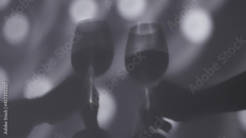 Shadow of hands holding wine glasses photo