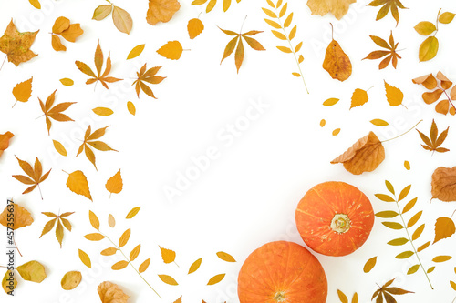 Autumnal frame composition with fall leaves and pumpkins on white background. Thanksgiving day concept. Flat lay