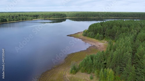 Flight over the taiga forest lake