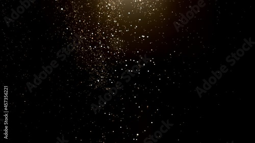 Super slow motion of abstract gold particles on black background. Filmed on high speed cinematic camera at 1000 frames per second. photo