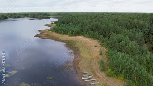 Flight over the taiga forest lake