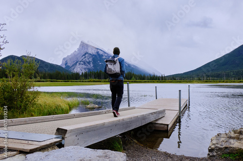 Pier on Vermillion lake with man and in the background mountain Rundle 1, Banff National Park photo