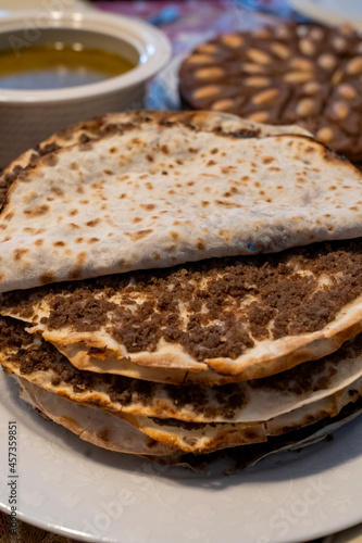 Lahmajun round, thin piece of dough topped with minced meat.