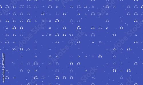 Seamless background pattern of evenly spaced white headphones symbols of different sizes and opacity. Vector illustration on indigo background with stars