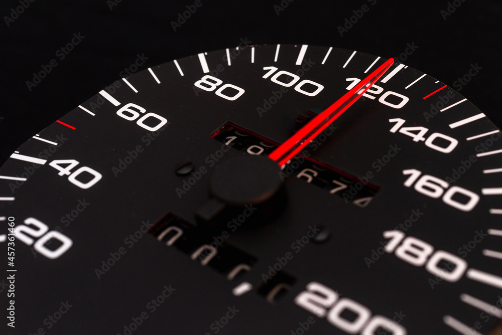 Car speedometer with the needle pointing a high speed at blackground, Speedometer with a red arrow indicating speeding, conceptual image for excessive speeding or careless driving concept.Close-up. Car speedometer with the needle pointing a high speed at blackground, Speedometer with a red arrow indicating speeding, conceptual image for excessive speeding or careless driving concept.Close-up.