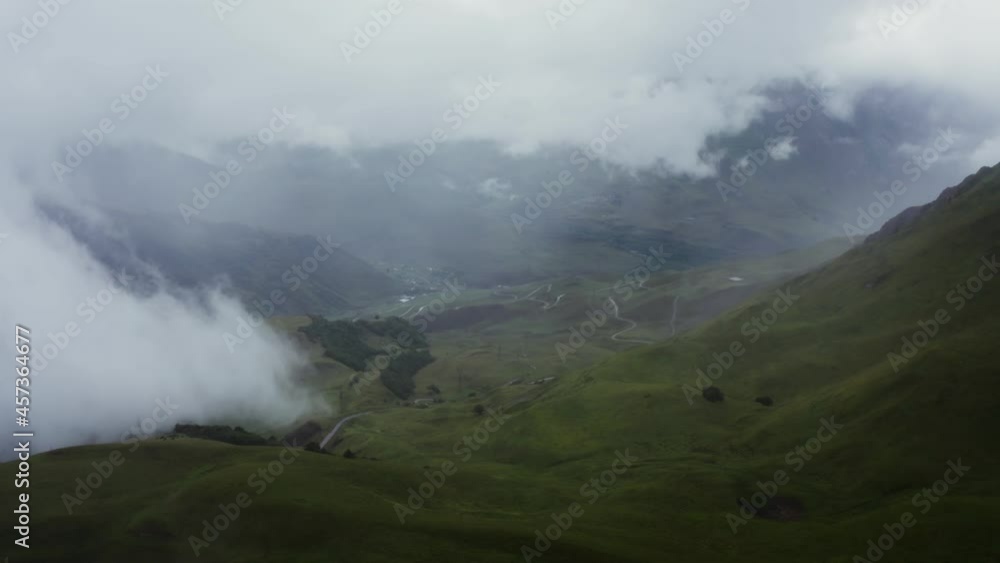 A beautiful view from a quadcopter to a mountain valley with a river in lowland A beautiful view from a quadcopter to a mountain valley with a river in lowland