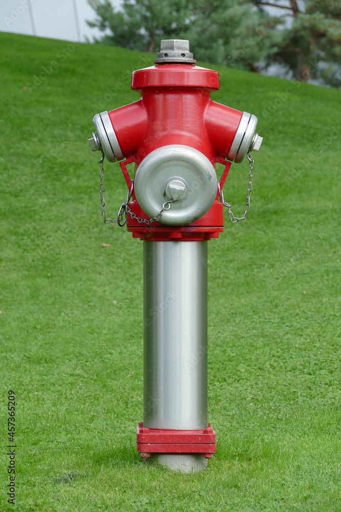 Fototapeta premium German fire hydrant placed in open green field to secure the neighboured people, Wolfsburg, Germany