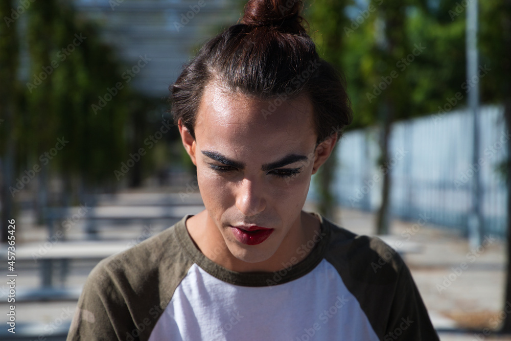 young latina transsexual woman is in a park where she is going to start doing her make-up for her big change from boy to girl. Concept of diversity, transgender, and freedom of homosexual expression. young latina transsexual woman is in a park where she is going to start doing her make-up for her big change from boy to girl. Concept of diversity, transgender, and freedom of homosexual expression.