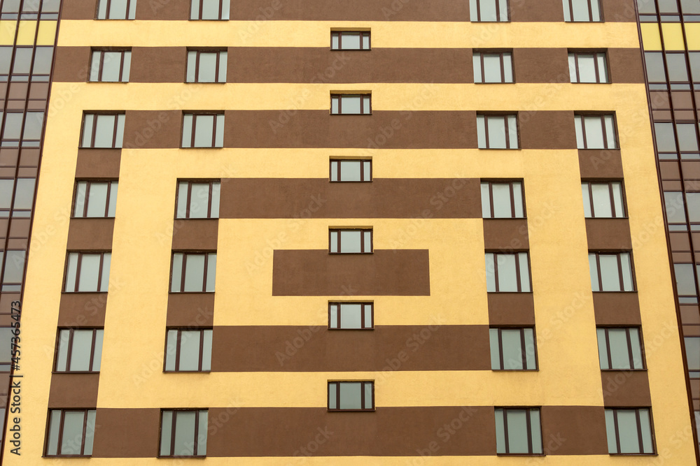 Facade of a modern European building painted with multi-colored geometric shapes.