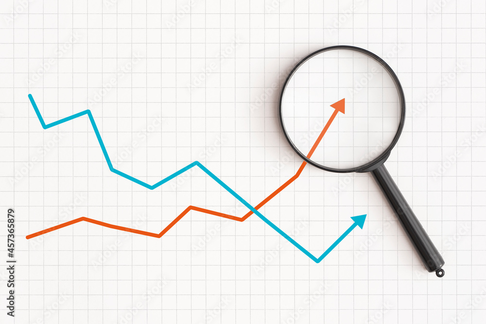 Business graph and magnifying glass on table. Financial development, Economy, Statistics Business graph and magnifying glass on table. Financial development, Economy, Statistics