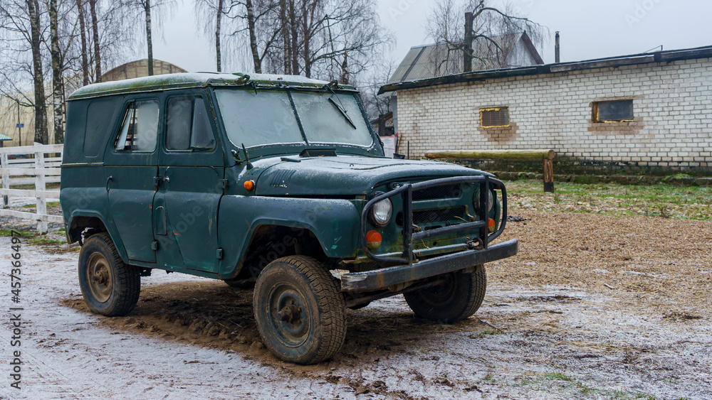 Off-road military light utility vehicle. Old Soviet car with in countryside.