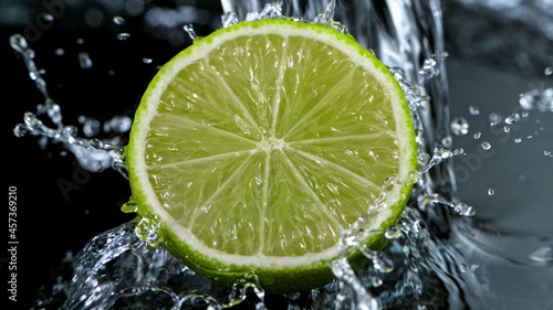 Freeze Motion Shot of Fresh Lime with Water Splash, close-up.