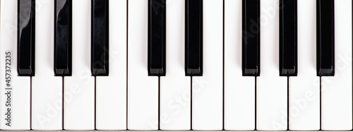 black and white piano keys, music synthesizer keys top view.