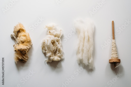 Four stages: raw wool, washed wool, combed wool and yarn photo