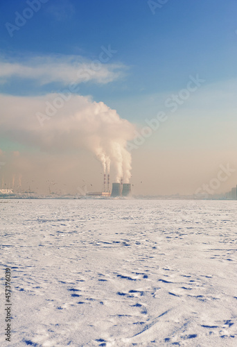 Winter city landscape with smoke of factories