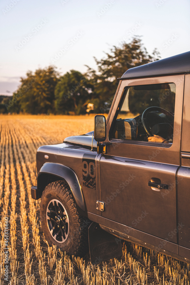 A man drives an all terrain vehicle in a field A man drives an all terrain vehicle in a field