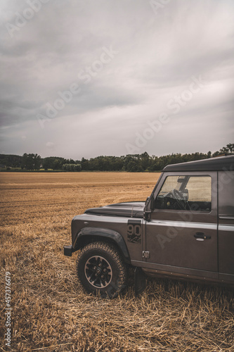 An all terrain vehicle drives in a field photo