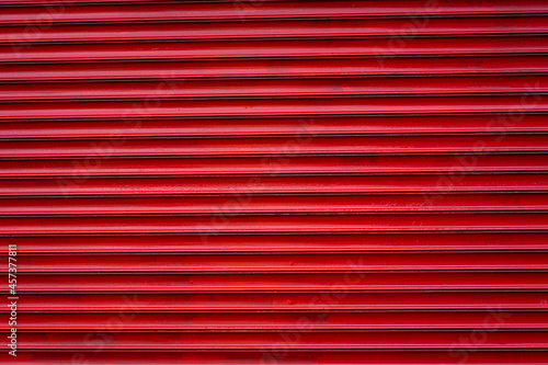 Red painted garage door closeup detail, useable as background. 