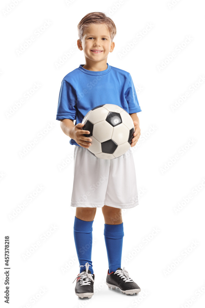 Cute little boy holding a soccer ball and smiling at camera Cute little boy holding a soccer ball and smiling at camera