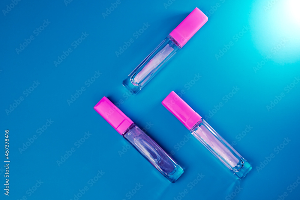 women's perfume in a transparent bottle on a lilac background with smoke women's perfume in a transparent bottle on a lilac background with smoke