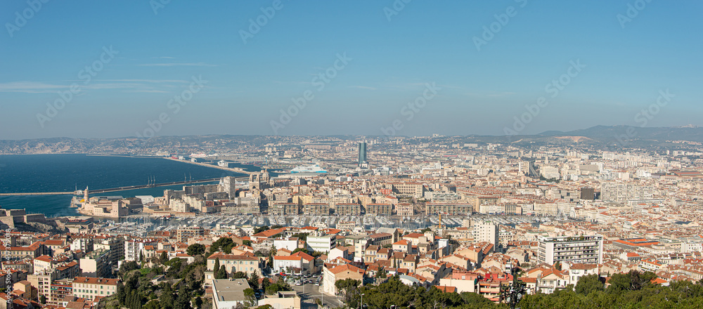 Panoramic bird view over modern center, port and suburbs in Marseille at sundown France, sunny day, blue sky