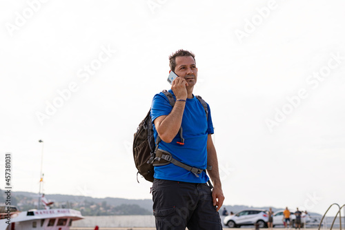 Young guy wearing sportswear and talking on the phone