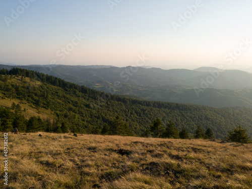 View of the slopes of the mountain Ozren from the peak Gostilj, a landscape of hilly Balkans at evening