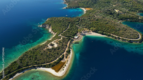 Aerial drone photo of organised with sunbeds and umbrelas paradise beach of Fanari with crystal clear turquoise sea, Meganisi island, Ionian, Greece