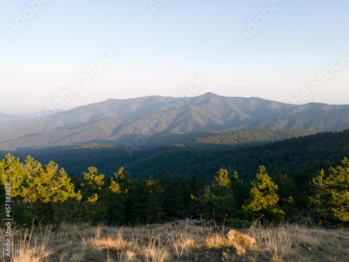 View of the slopes of the mountain Ozren from the peak Gostilj, a landscape of hilly Balkans at evening photo