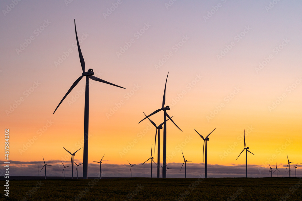 General view of wind turbines in countryside landscape during sunset General view of wind turbines in countryside landscape during sunset