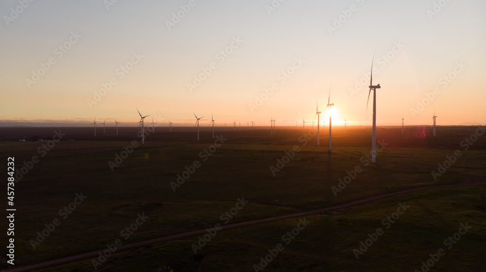 General view of wind turbines in countryside landscape during sunset General view of wind turbines in countryside landscape during sunset