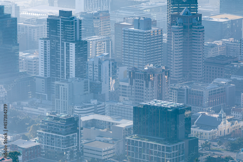 Obraz premium General view of cityscape with multiple modern buildings and skyscrapers in the foggy morning
