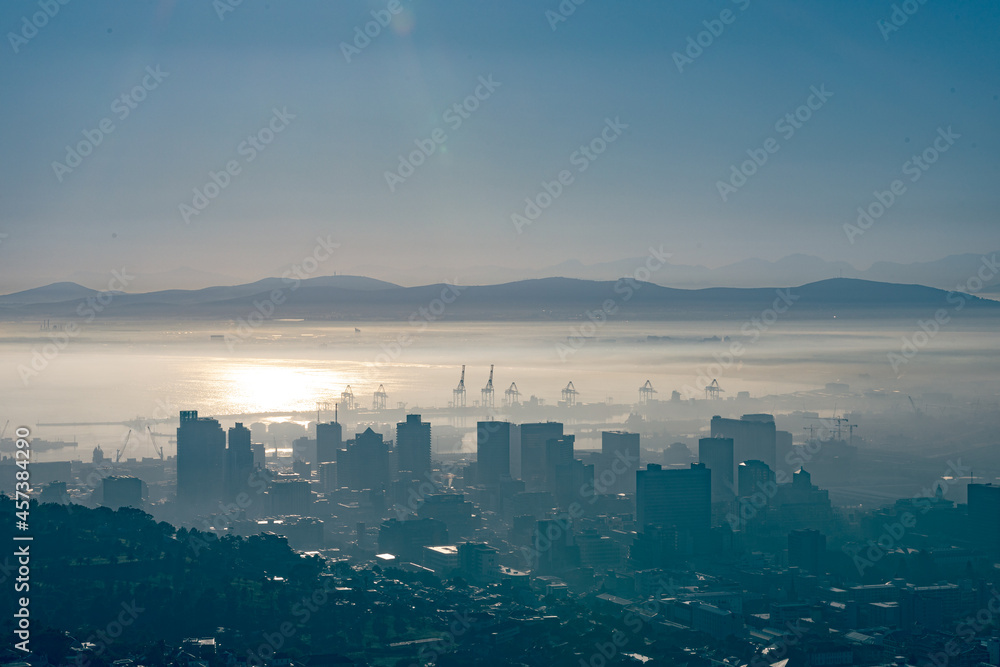 General view of cityscape with multiple modern buildings and skyscrapers in the foggy morning