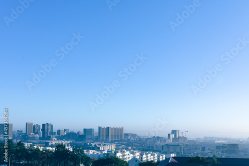 General view of cityscape with multiple modern buildings and skyscrapers in the morning © wavebreak3
