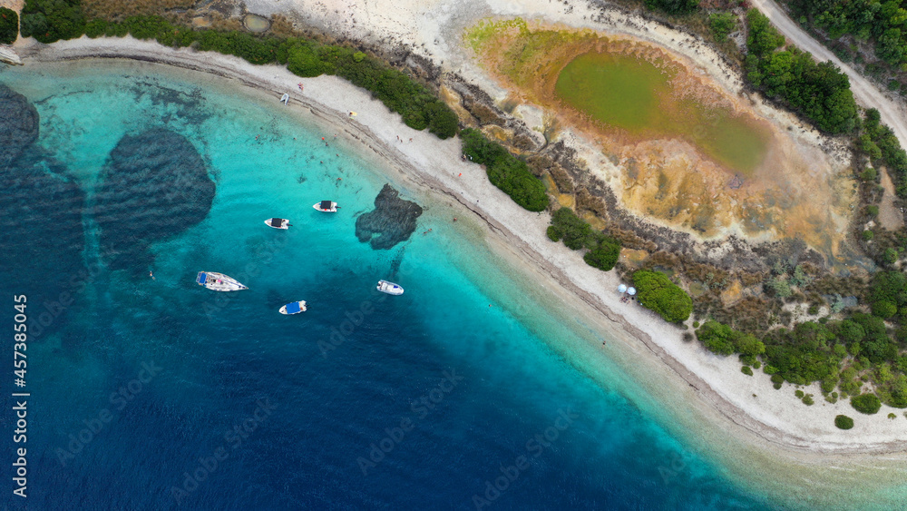 Aerial drone photo of exotic turquoise sandy beach forming a blue lagoon in tropical destination island bay