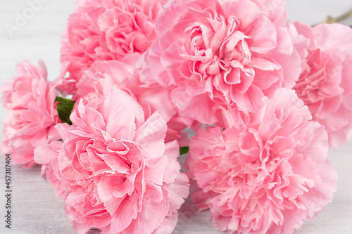 Soft pink floral background. A bouquet of carnations close-up, selective focus.
