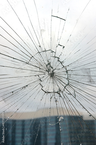 Broken glass. Glass cracked from an accident, blurred building background