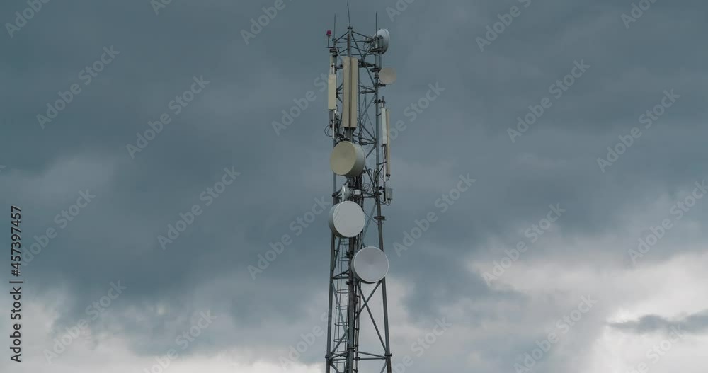 Zoom-in view of cell tower on clouds background Zoom-in view of cell tower on clouds background
