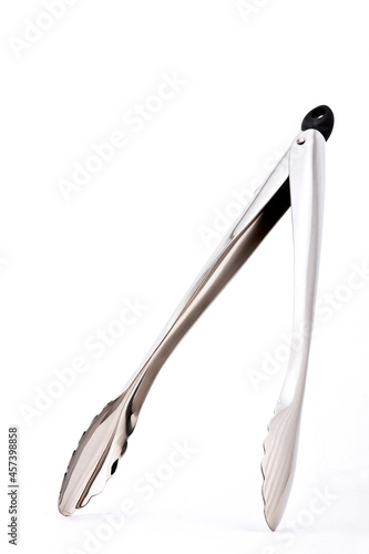 Metal kitchen tongs, stainless steel for serving, isolated on white background